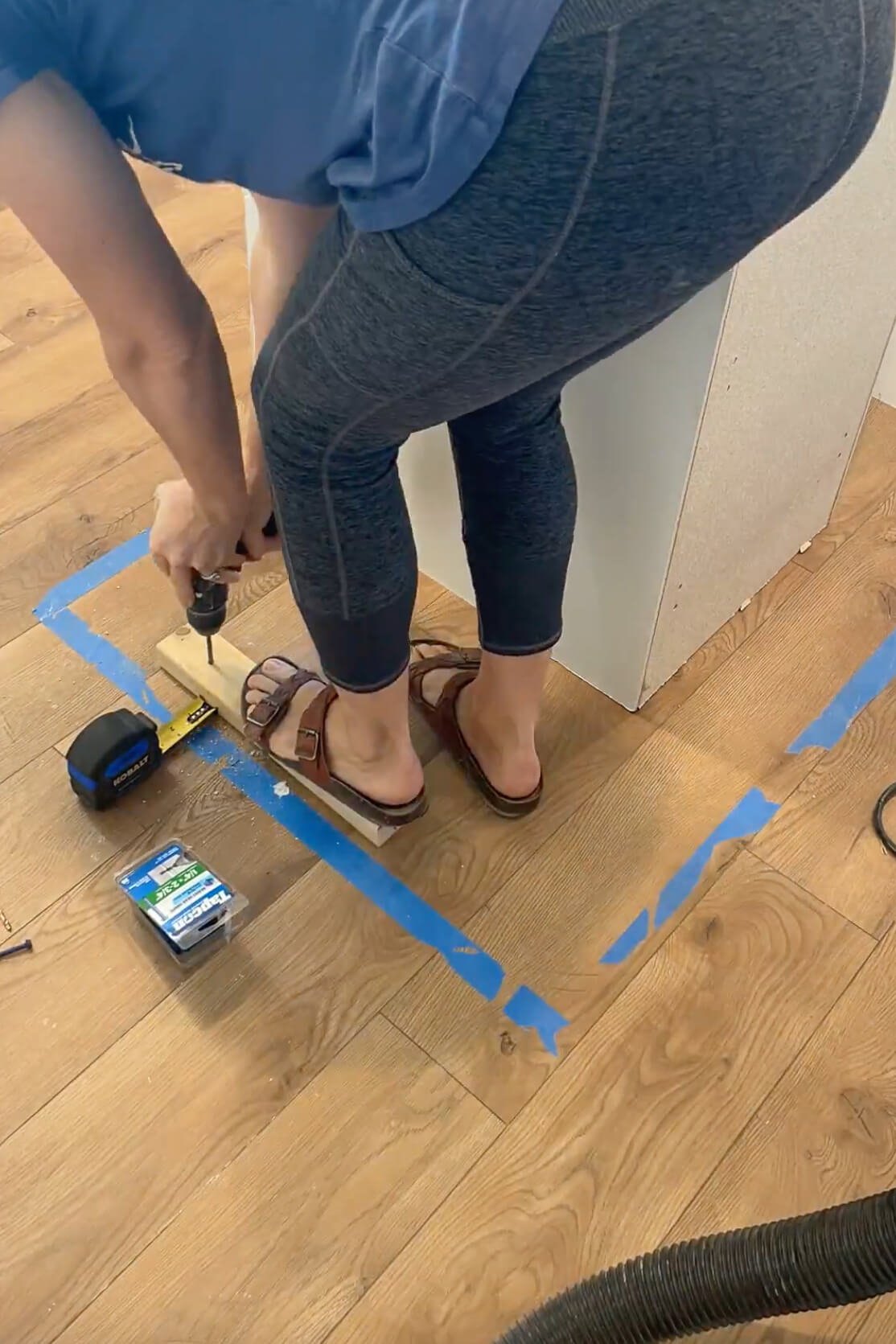 Attaching bracing to the floor for a kitchen island.